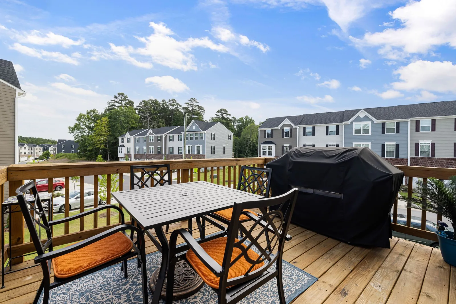 Deck vs patio cost comparison showing a raised wood deck beside a ground-level stone patio