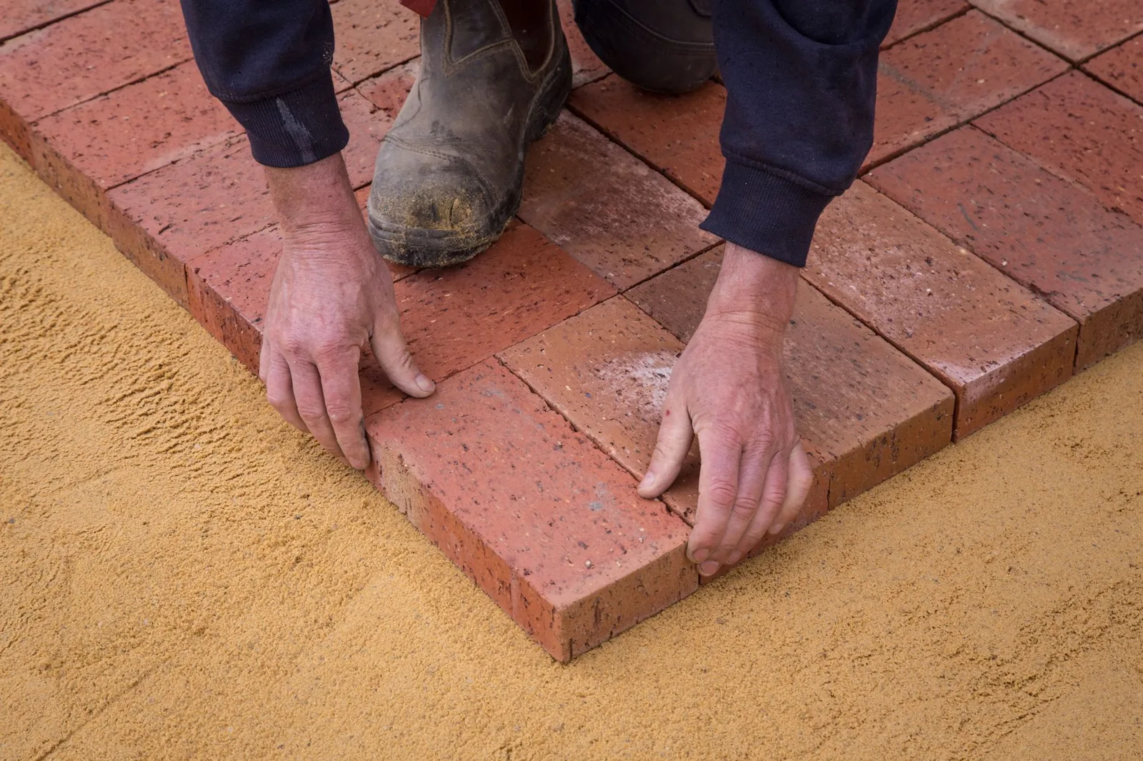Paver patio vs concrete: interlocking pavers bend with shifting soil instead of cracking like a solid slab