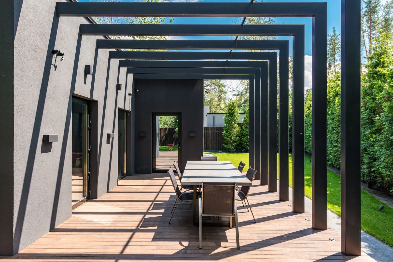 Freestanding wood pergola in a landscaped backyard