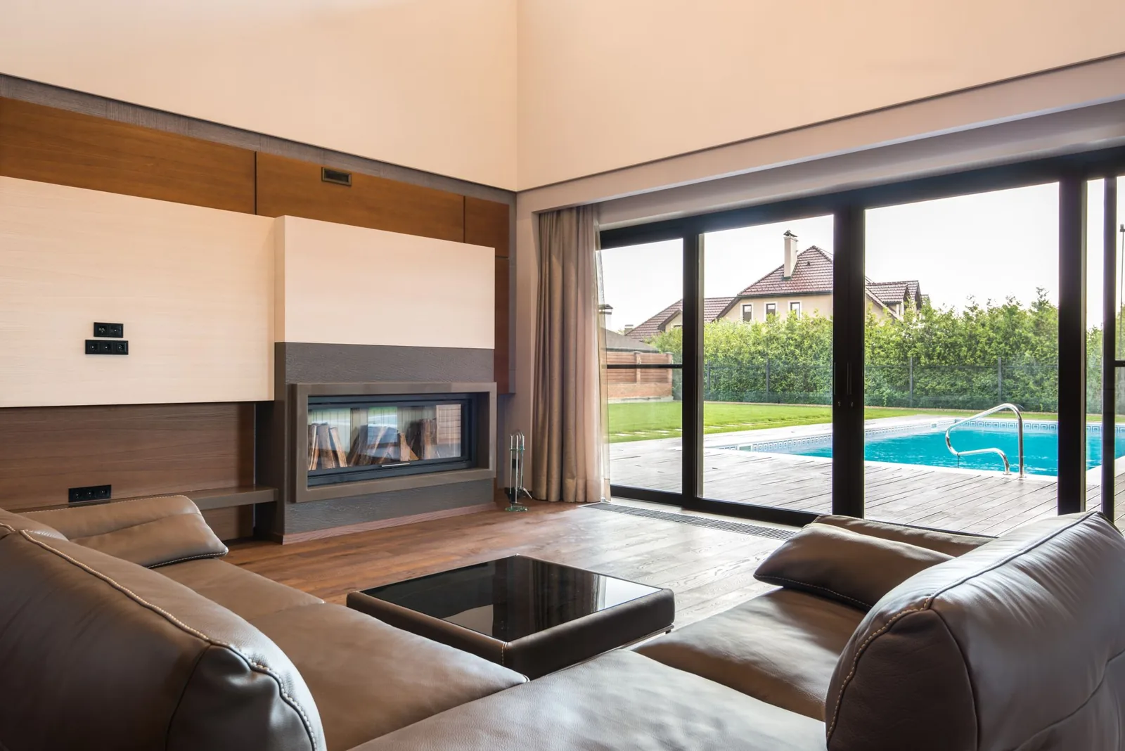 A pair of white French doors opening onto a bright backyard patio