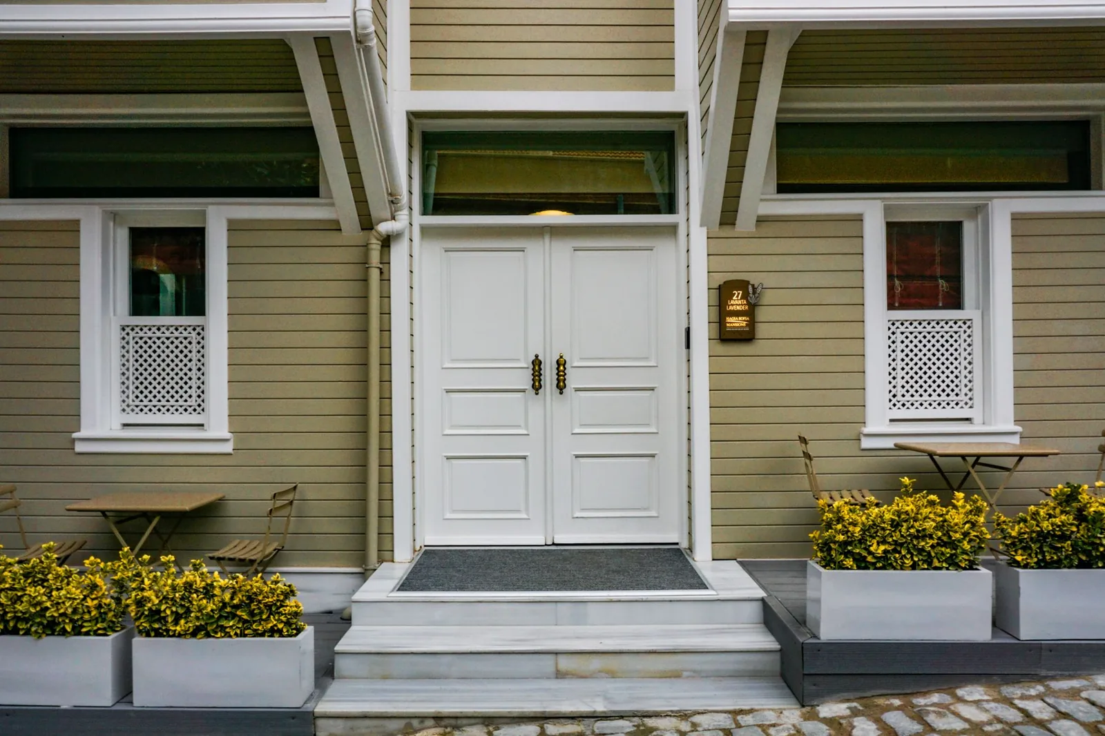 storm door vs screen door — a screen door over a wooden entry door